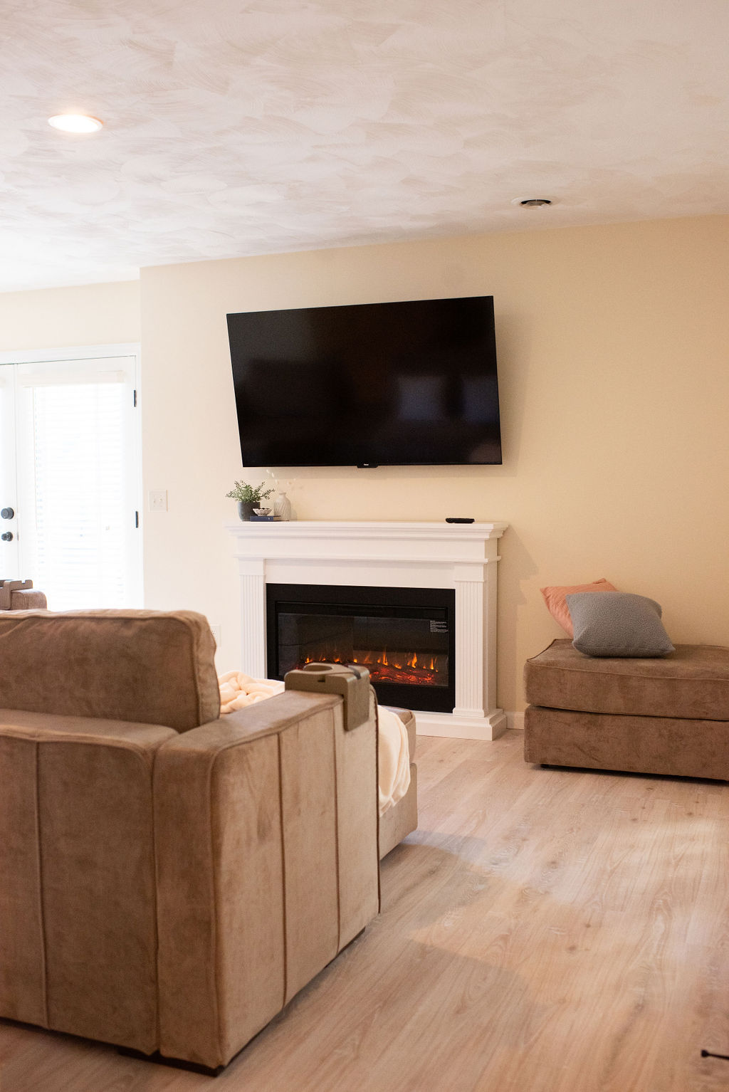 Living room with electric fireplace and TV